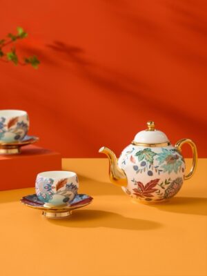Clarence 6‑piece Coffee Set, full two‑person koi‑floral gold‑trim coffee tea set panoramic display on vibrant orange‑red geometric background